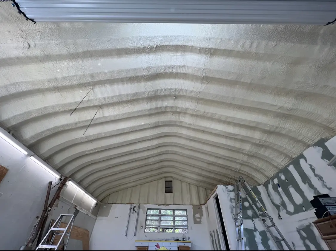 Spray polyurethane foam applied to the underside of a metal roof deck in Hinsdale